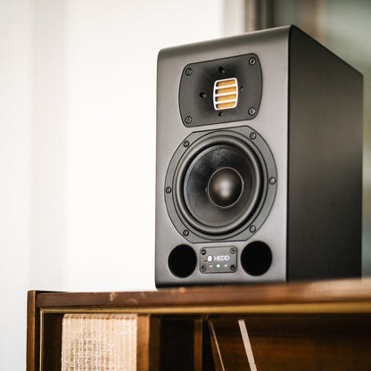 TYPE 05 ACORE on a wooden cabinet with a white wall background