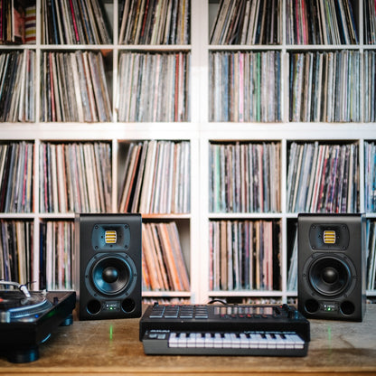 TYPE 05 ACORE and keyboard on a table with record shelves in the background.