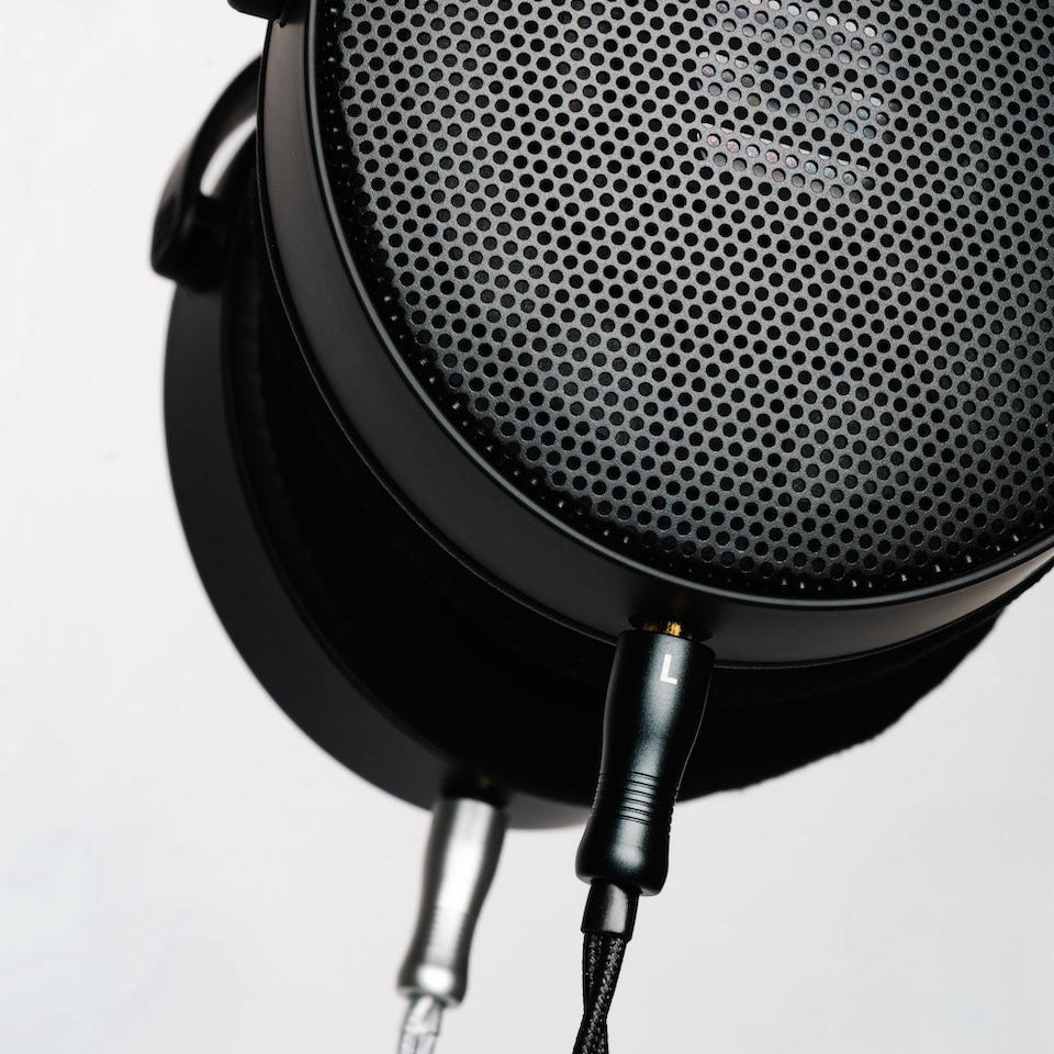 Close-up of a HEDDphone D1 with upgrade audio cable plugged in.