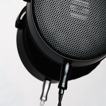 Close-up of a HEDDphone D1 with upgrade audio cable plugged in.
