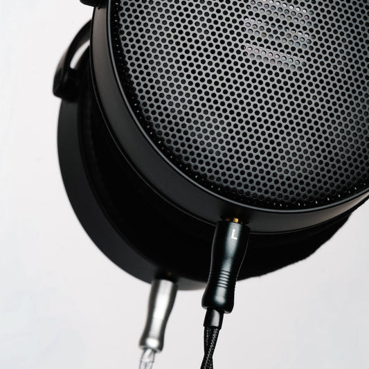 Close-up of a HEDDphone D1 with upgrade audio cable plugged in.