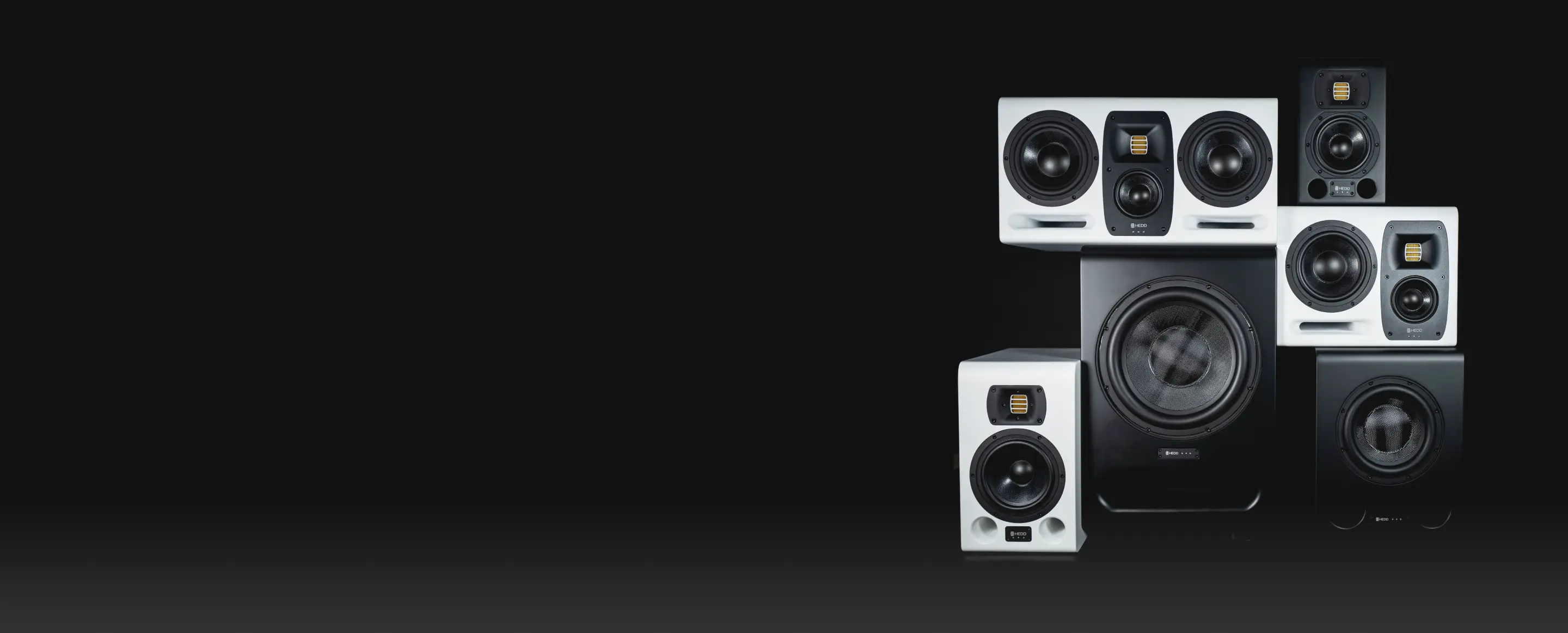 A group of HEDD speakers and subwoofers