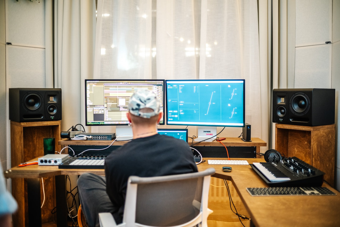 Person at a desk using the HEDD CTRL software with HEDD MK2 monitors and audio equipment