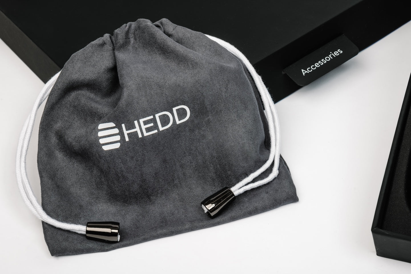 Gray drawstring bag with 'HEDD' logo on a white surface
