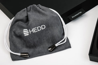 Gray drawstring bag with 'HEDD' logo on a white surface