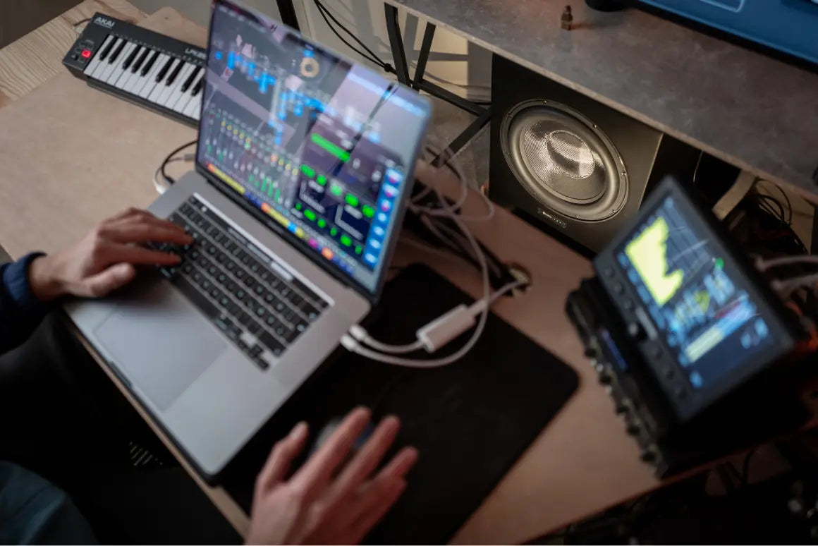 Bass 08 subwoofer behind a laptop