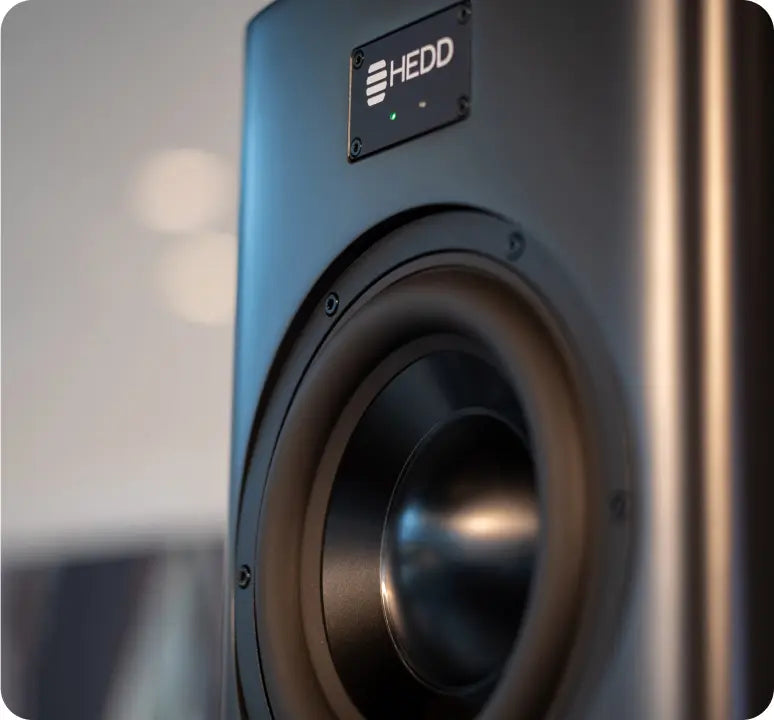 Close up of the right of a tower main speaker with the HEDD logo